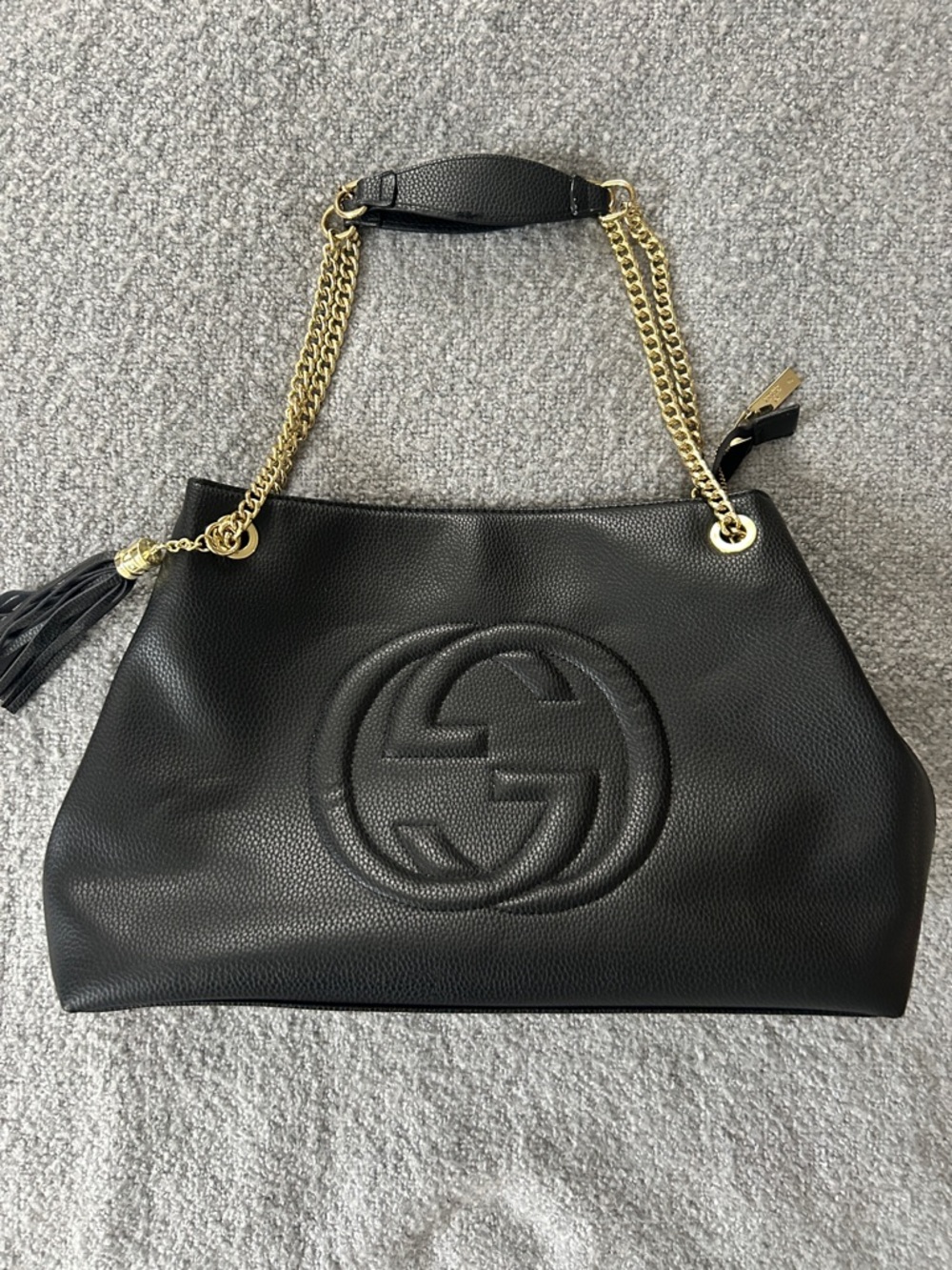 Black Pebbled Leather Shoulder Bag with Gold Chain Straps and Tassel